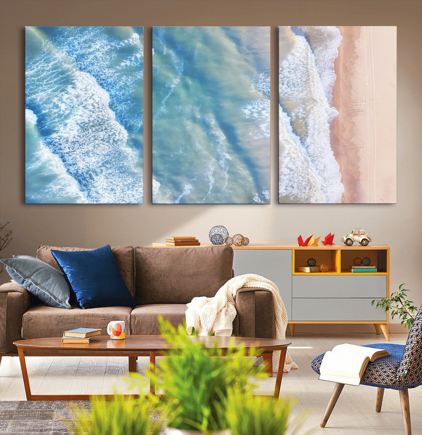 Aerial photo of soft blue waves meeting sandy shore, perfect for modern coastal or beach-themed decor with a light and tranquil aesthetic.