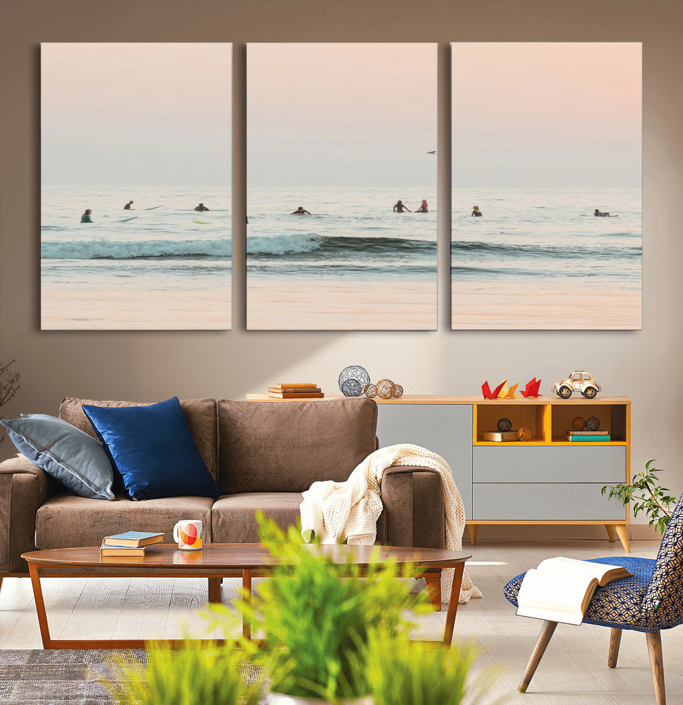 Dreamy photo of surfers waiting on soft pastel waves under a pink sunset sky, ideal for soft coastal minimalist or serene ocean-themed home decor.