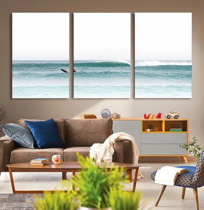 Minimalist photo of a lone surfer on calm aqua waves under bright sky, perfect for Scandinavian coastal or serene ocean-inspired home decor.