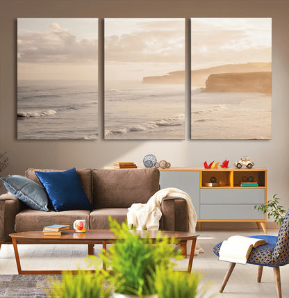 Golden hour seascape with misty cliffs and gentle waves rolling towards the shore, capturing a tranquil and warm coastal atmosphere.