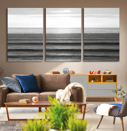 Minimalist black and white ocean view with layered waves reflecting sunlight, evoking a sense of calm and coastal serenity.