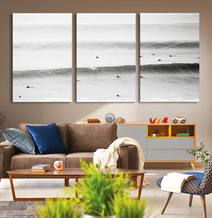 A monochrome photograph of swimmers gliding through gentle ocean waves, evoking a sense of calm and movement.
