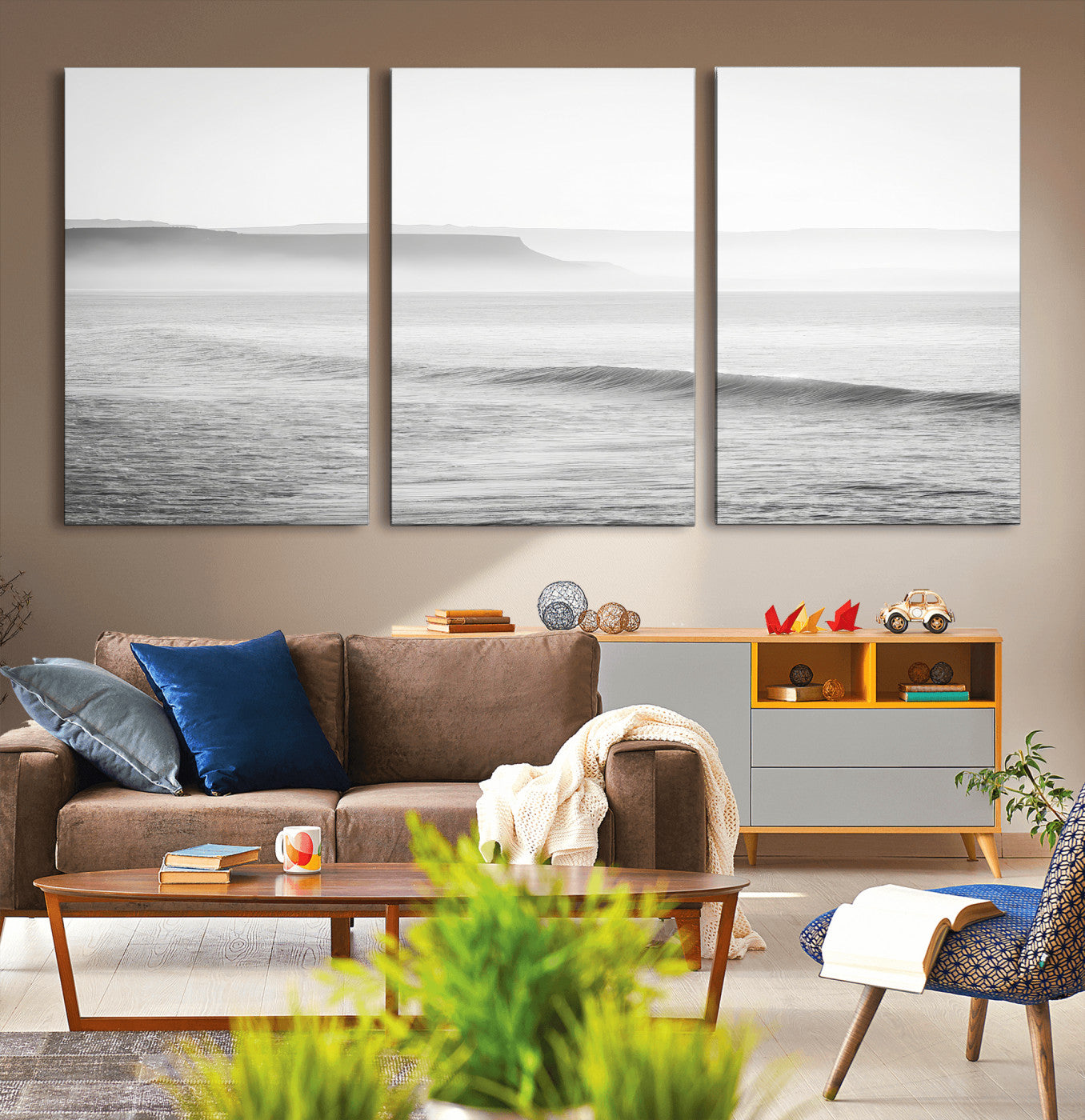 A black and white minimalist seascape featuring soft rolling waves and misty distant cliffs, creating a serene and timeless coastal atmosphere.