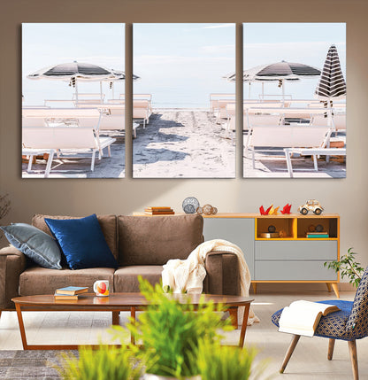 A serene minimalist beach scene featuring striped umbrellas, soft pastel sand, and an elegant lounge setup, creating a tranquil and stylish coastal retreat.