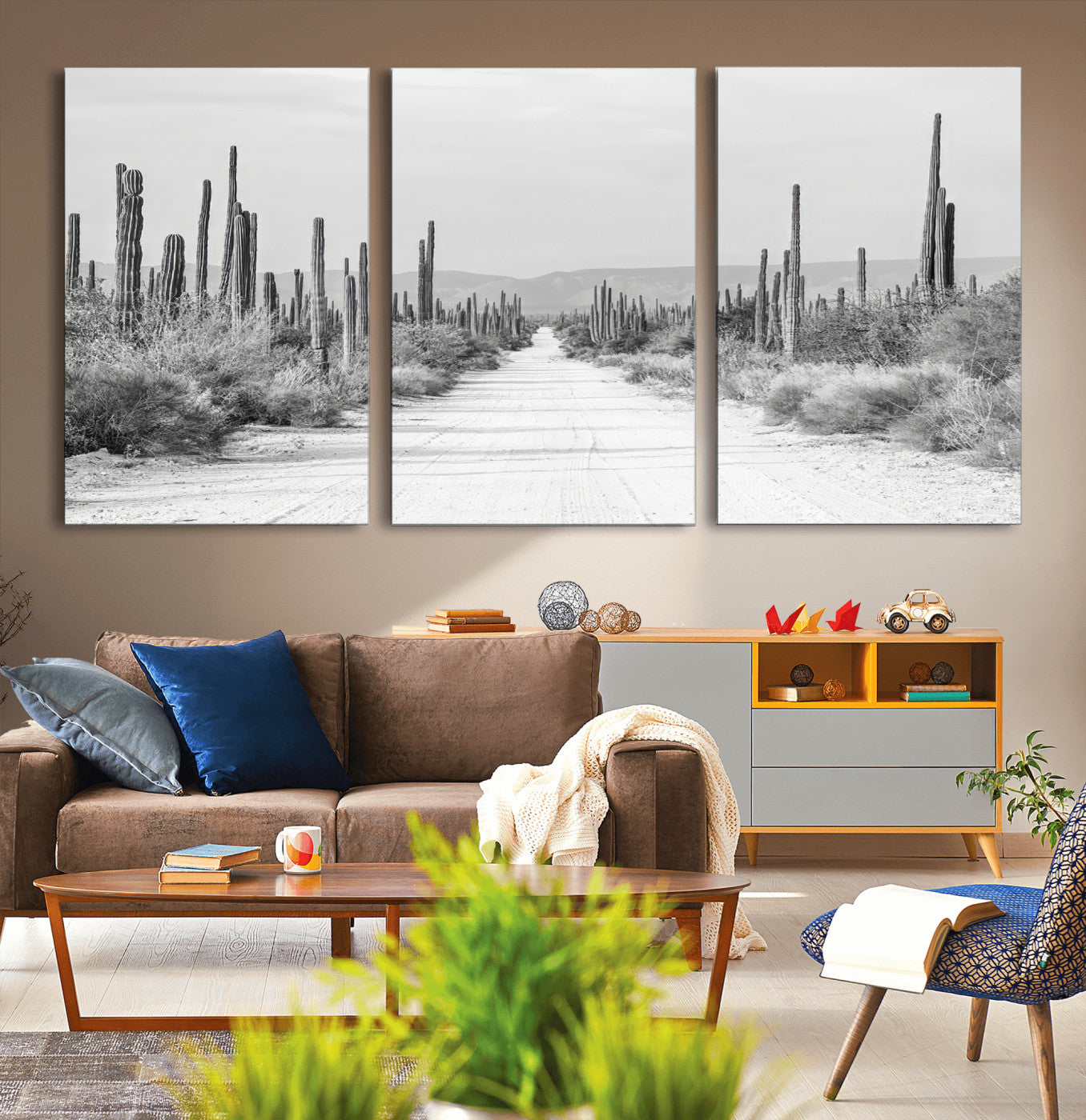 A black and white desert road stretching through a cactus-filled landscape, creating a rugged and timeless southwestern aesthetic with a sense of adventure.
