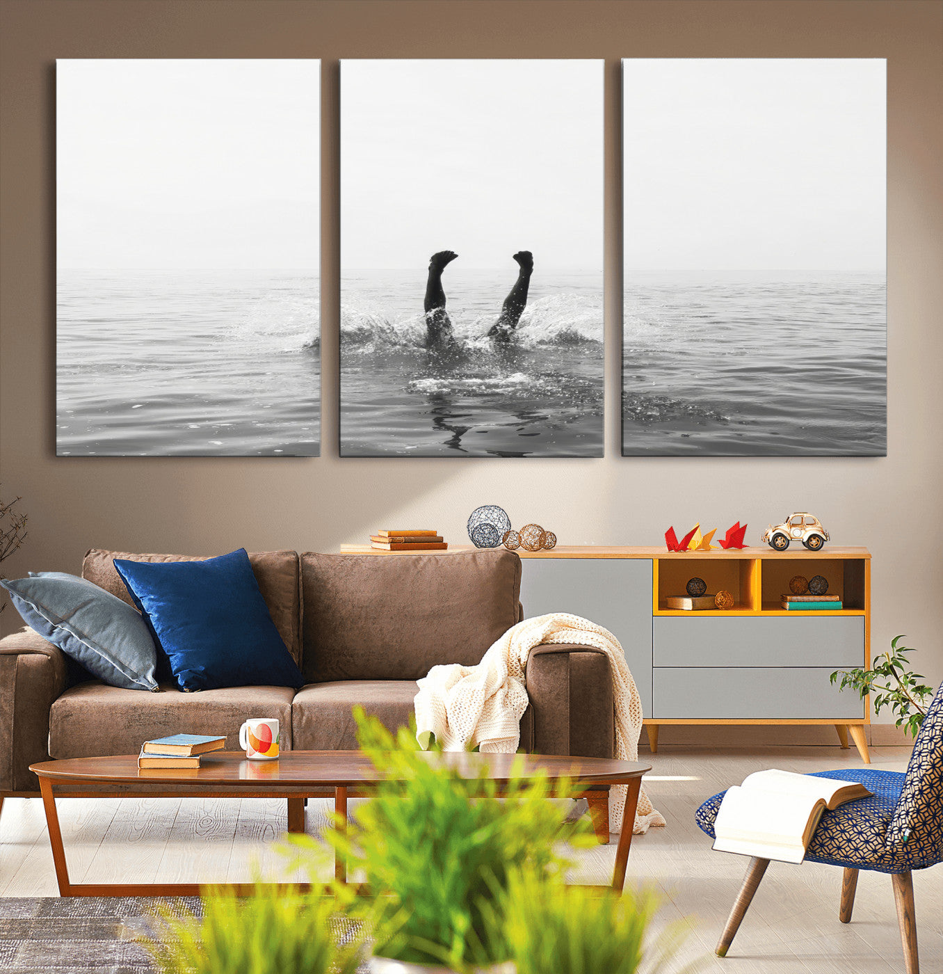 A black and white minimalist water scene capturing a playful splash as a swimmer dives upside down, creating a carefree and artistic aquatic aesthetic.