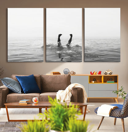 A black and white minimalist water scene capturing a playful splash as a swimmer dives upside down, creating a carefree and artistic aquatic aesthetic.
