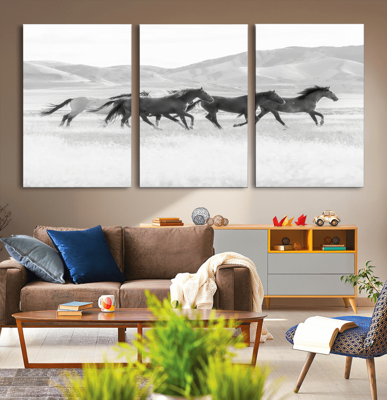 A black and white image of wild horses running freely across an open grassland, capturing the power and beauty of untamed nature in a rustic western setting.