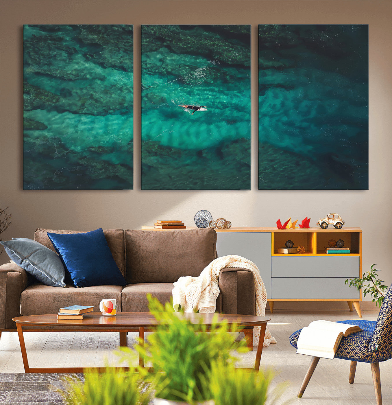 An aerial view of a solo surfer paddling through crystal-clear turquoise waters over a sunlit reef, capturing the beauty and serenity of open water surfing.