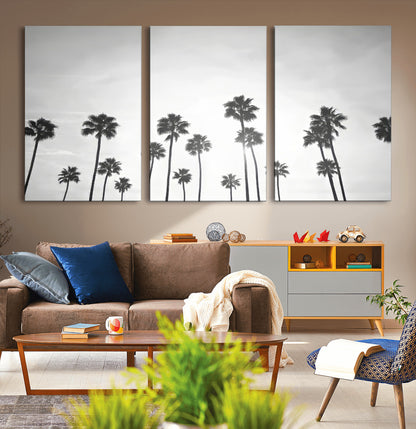A black and white minimalist scene featuring tall palm trees silhouetted against a bright sky, creating a dreamy and timeless tropical aesthetic.