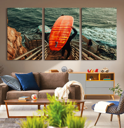 A surfer carrying a bold orange surfboard down a rugged staircase toward the ocean, bathed in golden hour light, capturing the energy of coastal adventure.