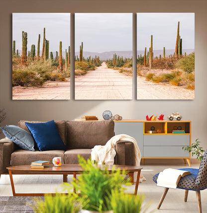 A desert road lined with saguaro cacti under a golden sky, creating a warm southwestern feel, perfect for boho or rustic decor.