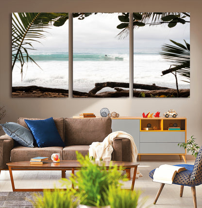 Tropical beach view with palm trees and surfer riding a wave, perfect for boho or coastal-inspired interior wall decor.