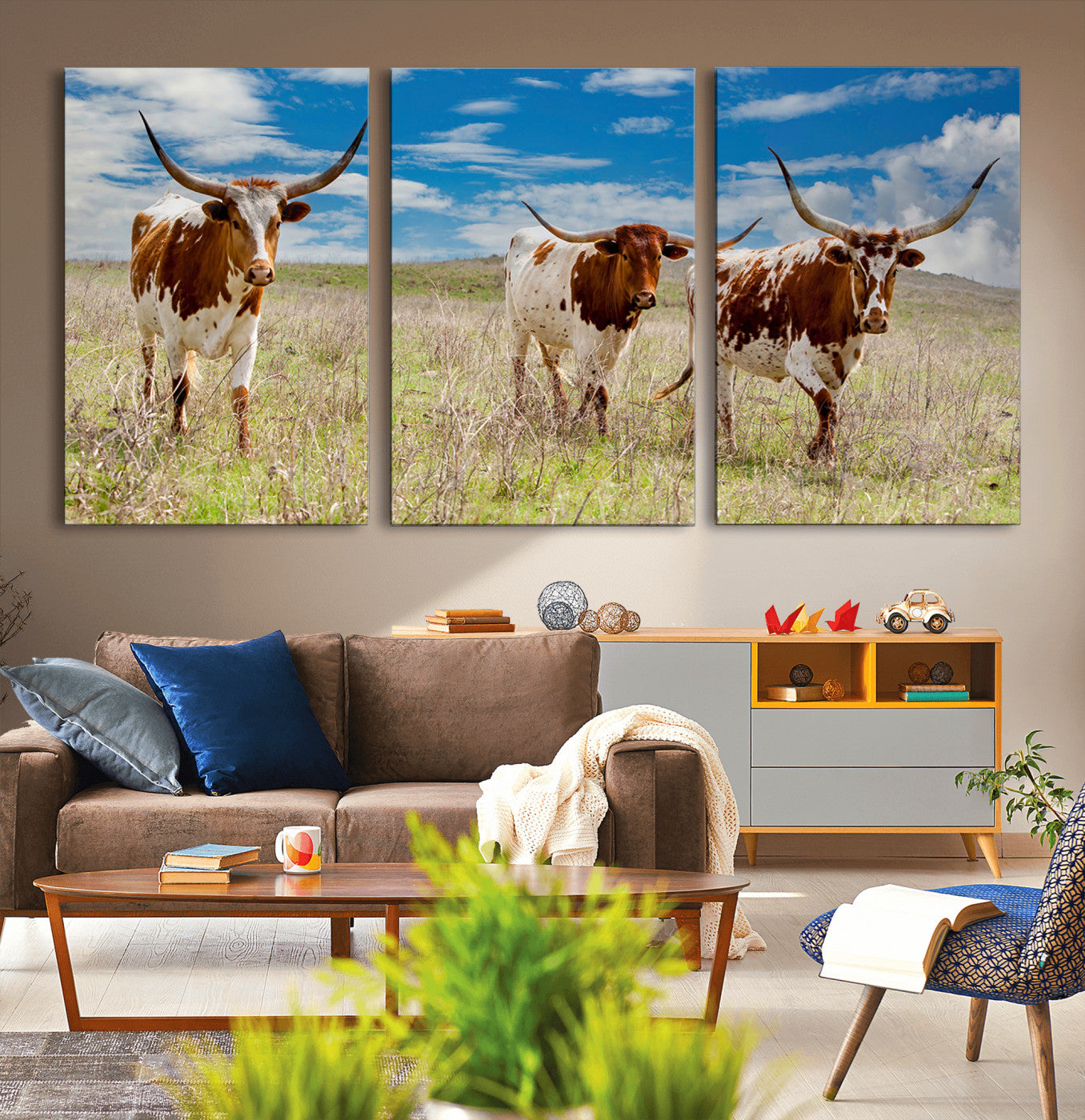 Three Texas longhorn cattle standing in dry grass under a bright blue sky, ideal for farmhouse or western rustic home decor.