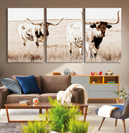Two Texas longhorn cows standing in a sepia-toned pasture, evoking rustic charm perfect for farmhouse or western country interiors. (