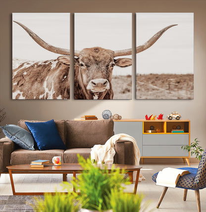 A longhorn cow in soft beige desert tones, standing calmly in open land, perfect for neutral western or rustic farmhouse interiors.