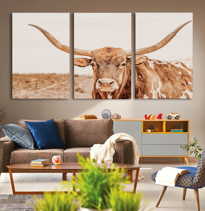 A longhorn bull standing proudly in a sunlit desert field with warm neutral tones, ideal for rustic western or farmhouse interiors.