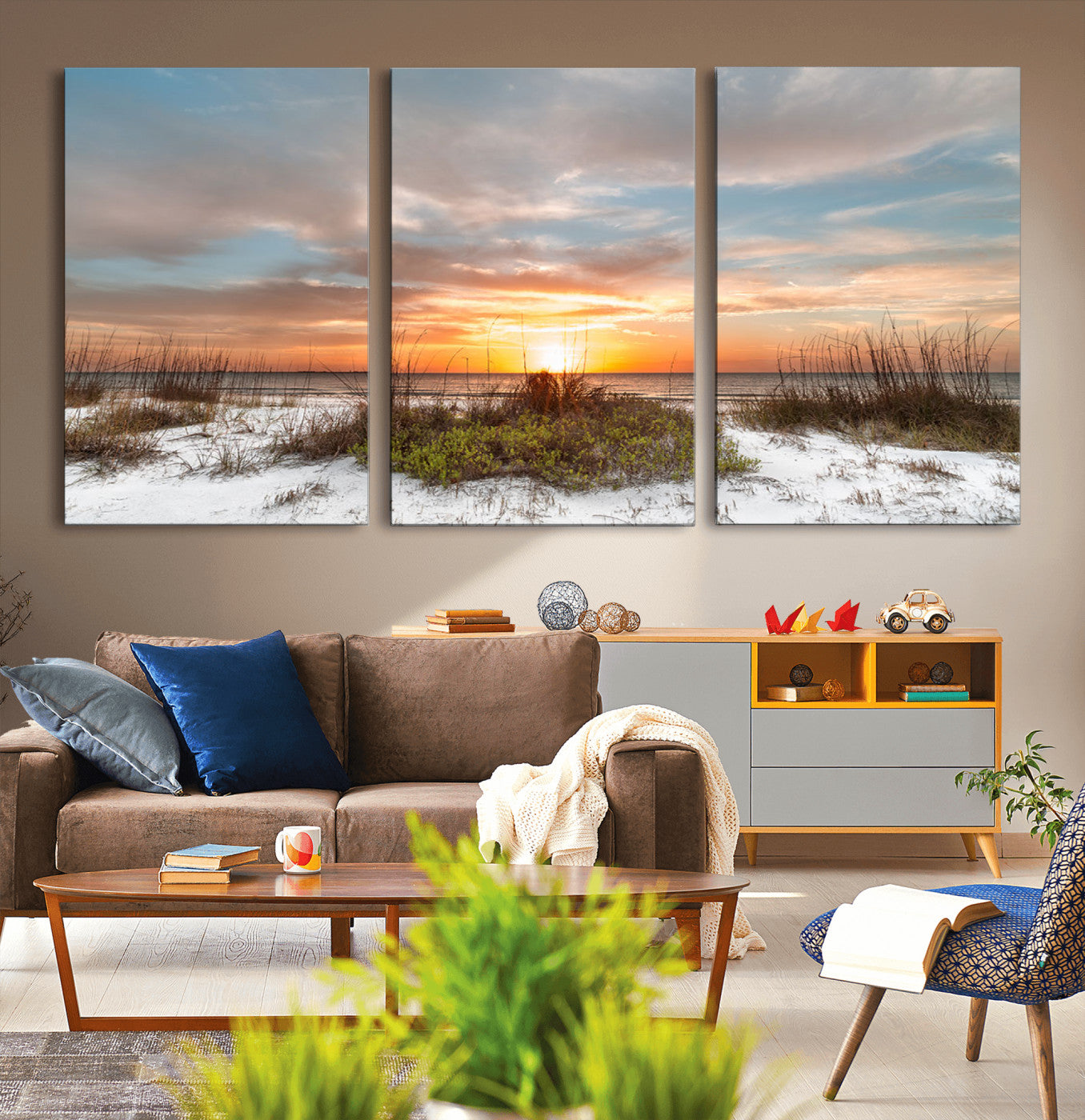 A tranquil beach scene featuring golden sunset hues over the water, with grasses in the foreground and a peaceful, serene atmosphere.