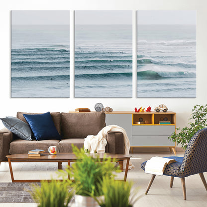 High-angle view of surfers lining up across layered ocean waves, ideal for minimal coastal or surf-inspired room decor.