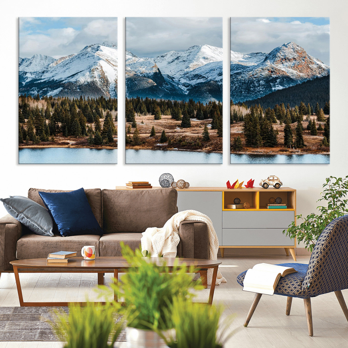 Framed canvas of snowy mountain peaks with pine forest and alpine lake, perfect for winter cabin or wilderness-inspired home decor.