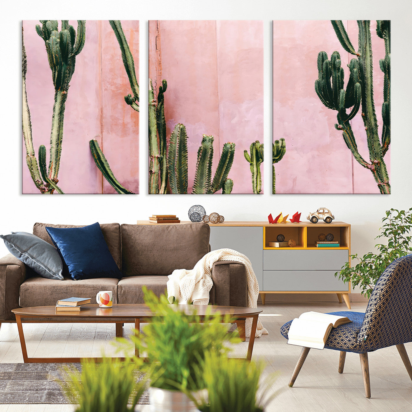Framed canvas of tall green cacti against a soft pink wall, ideal for modern desert or colorful southwest-inspired home decor.