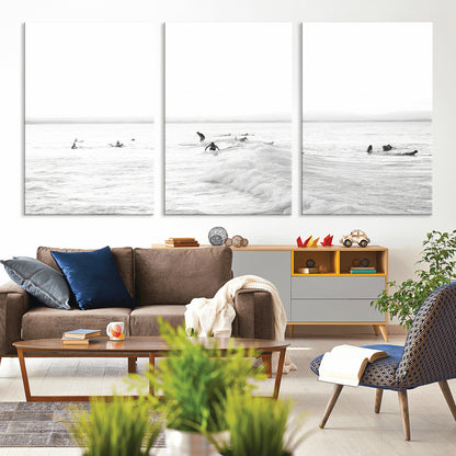Monochrome photo of surfers riding and waiting on ocean waves, ideal for surf-themed or coastal energy wall decor.