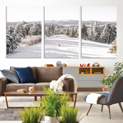 Bright ski trail lined with snow-covered pines and a skier in orange, perfect for alpine adventure or winter sports-inspired decor.