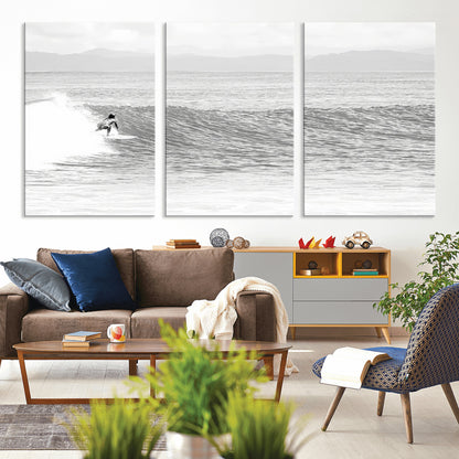Monochrome photo of a surfer riding a wave with distant mountains, ideal for coastal motion or black and white surf-themed wall decor.