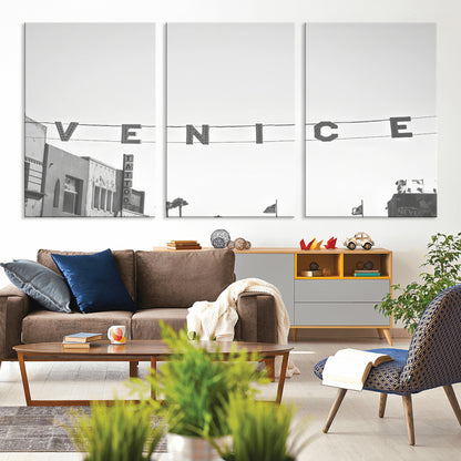 Black and white photo of Venice Beach sign and palm-lined street, perfect for urban coastal or minimalist LA-inspired wall decoration.