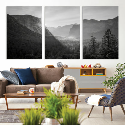 Black and white landscape of Yosemite with sun rays peeking over El Capitan, ideal for moody nature or modern rustic decor.