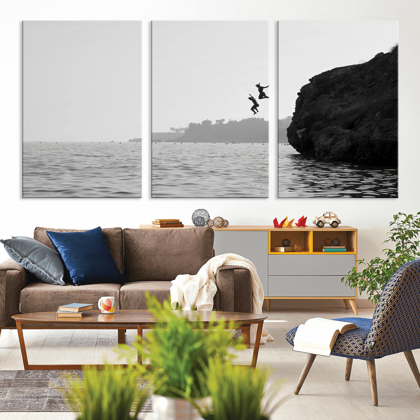 Black and white canvas of two figures cliff jumping into the sea, captured with moody tones, ideal for modern coastal or adventure-themed home decor.   2/2