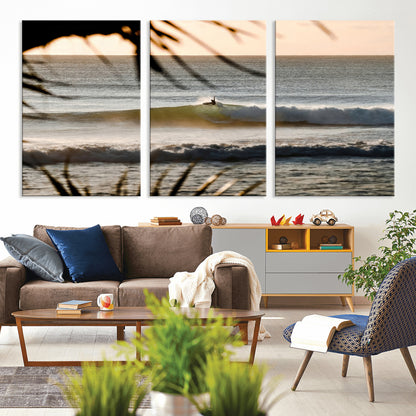 Photo of a surfer riding a golden hour wave at sunset, with tropical tones and dreamy light, perfect for tropical boho or coastal home decor.