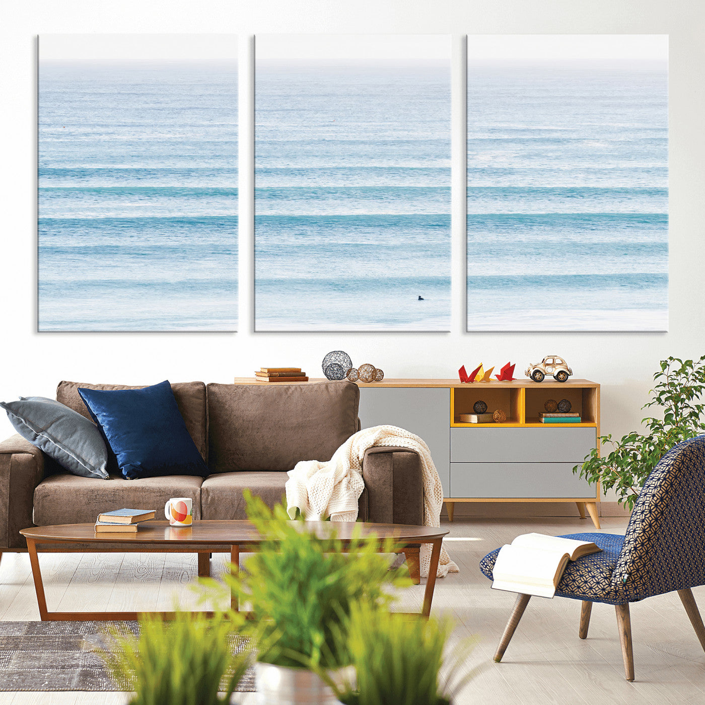 Minimalist ocean view with soft blue waves and a lone surfer, creating a serene and airy coastal aesthetic, perfect for tranquil home decor.