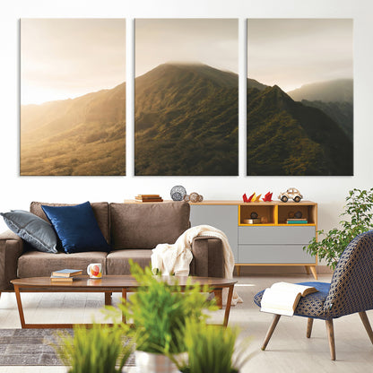 Sunlit mountain peak with mist rolling over its rugged slopes, bathed in golden light, creating a warm and tranquil nature-inspired scene.