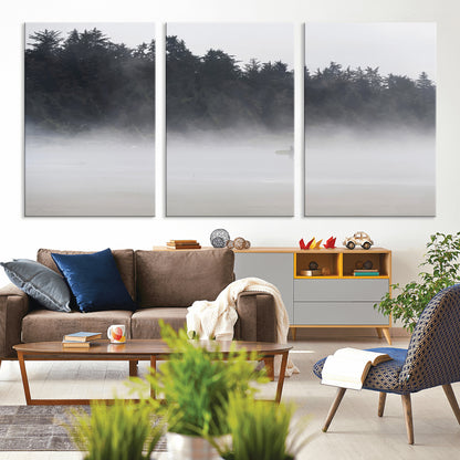 A lone surfer carrying a board through a misty shoreline, surrounded by dense trees and fog, creating a peaceful and mysterious coastal scene.
