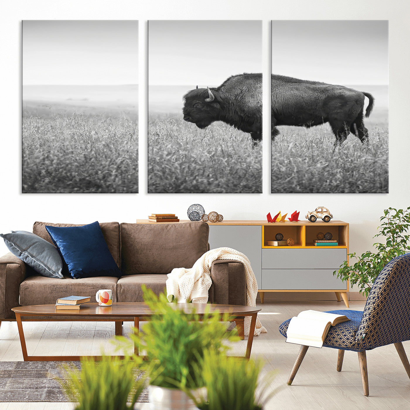 A black and white photograph of a majestic bison standing in a vast grassy prairie, evoking a sense of wilderness and strength.