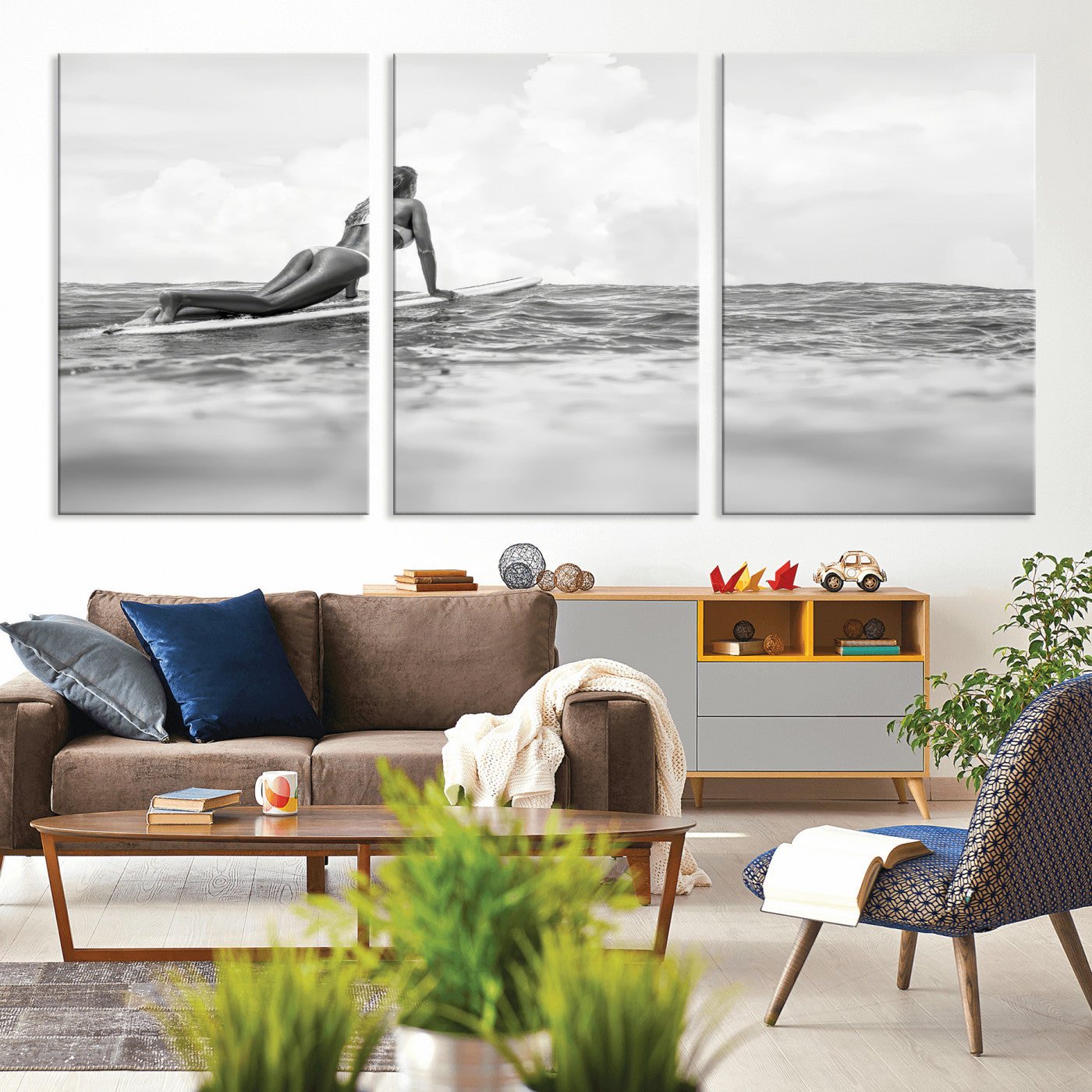 A black and white ocean scene featuring a surfer girl waiting on her board, gazing at the horizon, capturing a tranquil and adventurous coastal moment.