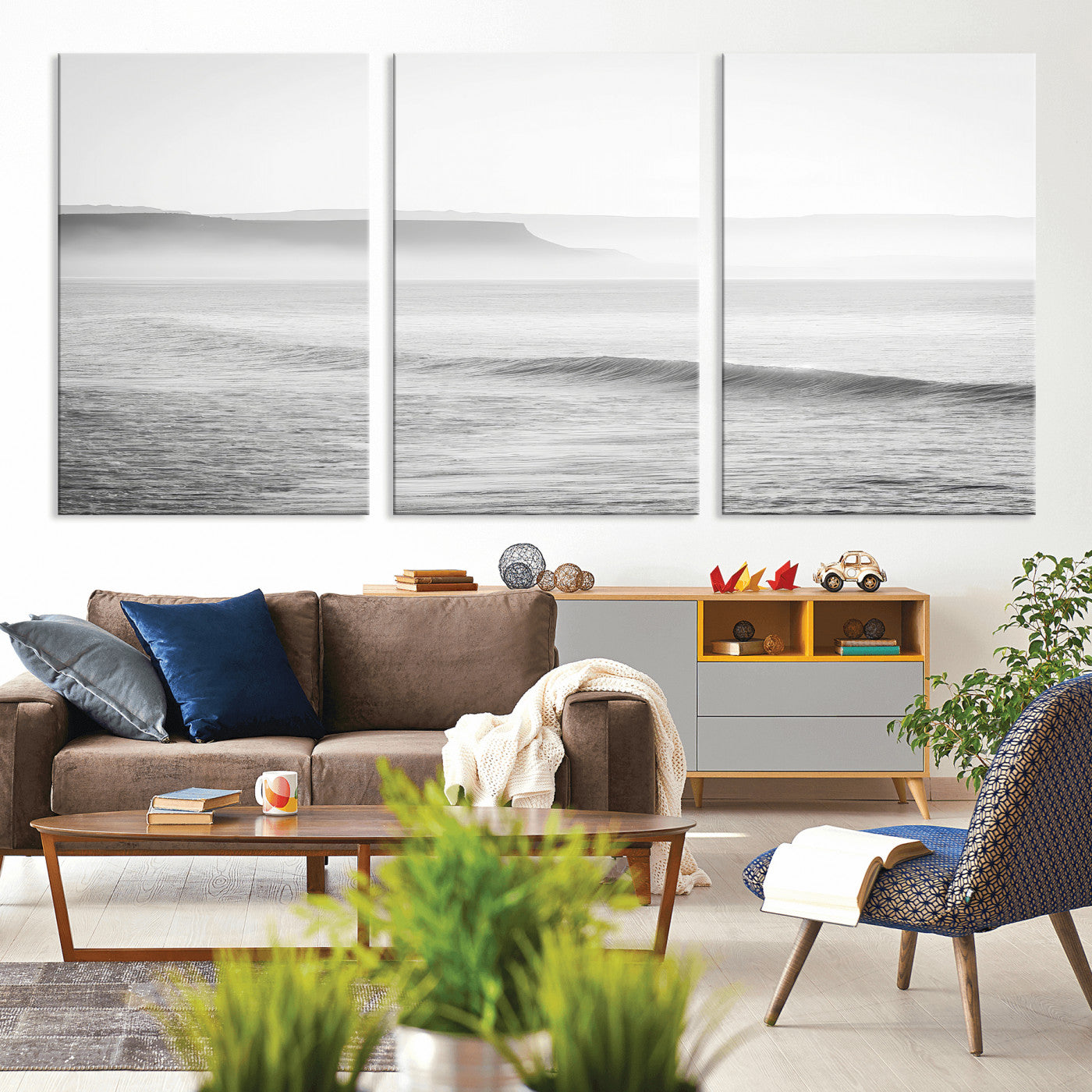A black and white minimalist seascape featuring soft rolling waves and misty distant cliffs, creating a serene and timeless coastal atmosphere.