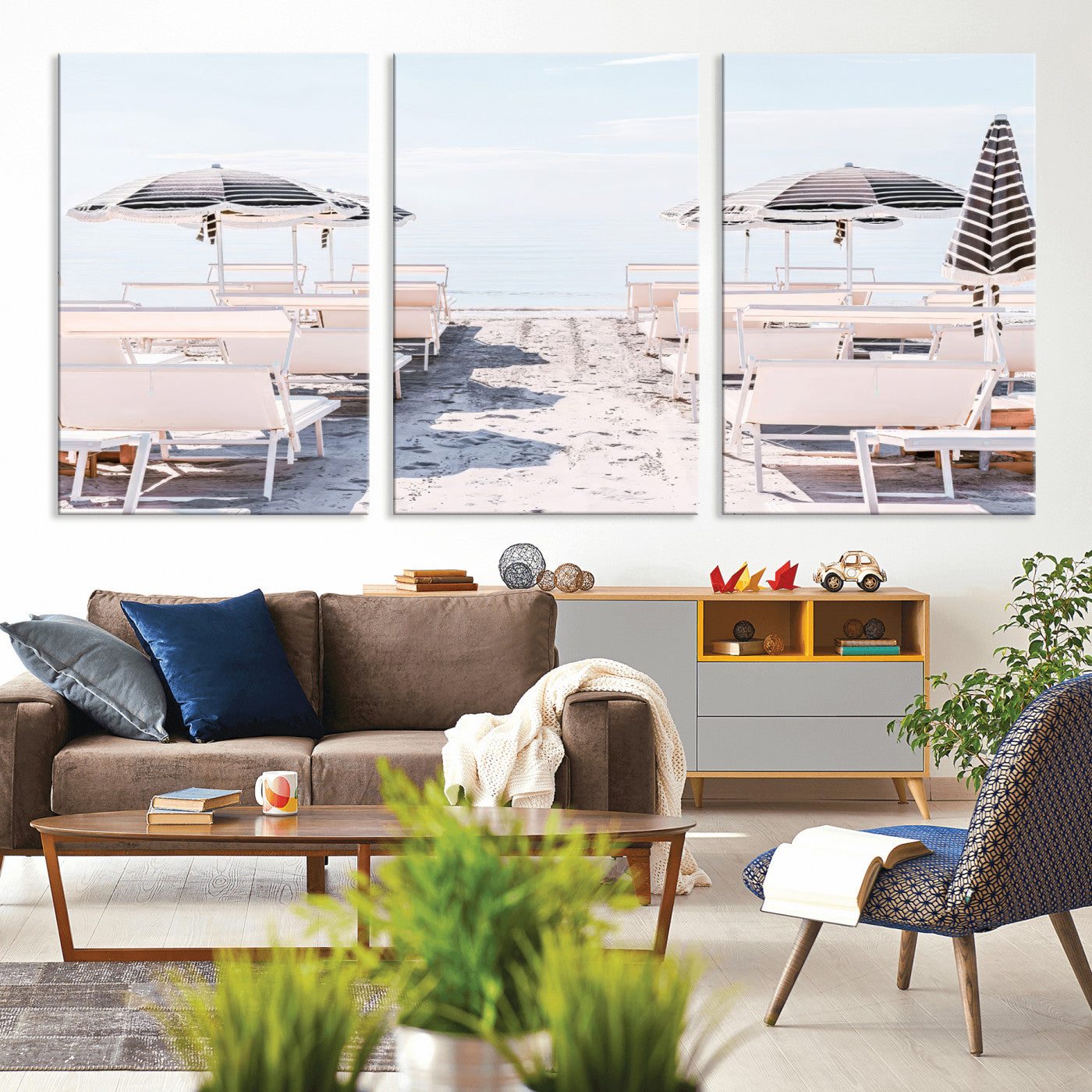 A serene minimalist beach scene featuring striped umbrellas, soft pastel sand, and an elegant lounge setup, creating a tranquil and stylish coastal retreat.