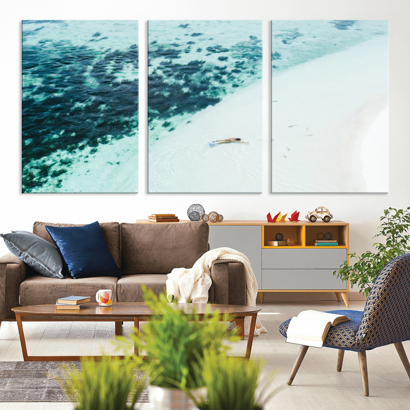 Canvas featuring an aerial view of a swimmer in shallow turquoise waters with coral patterns, ideal for tropical coastal home decor.