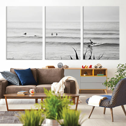 Monochrome canvas of surfers on calm ocean waves, ideal for minimalist coastal or beach-inspired interior decor.