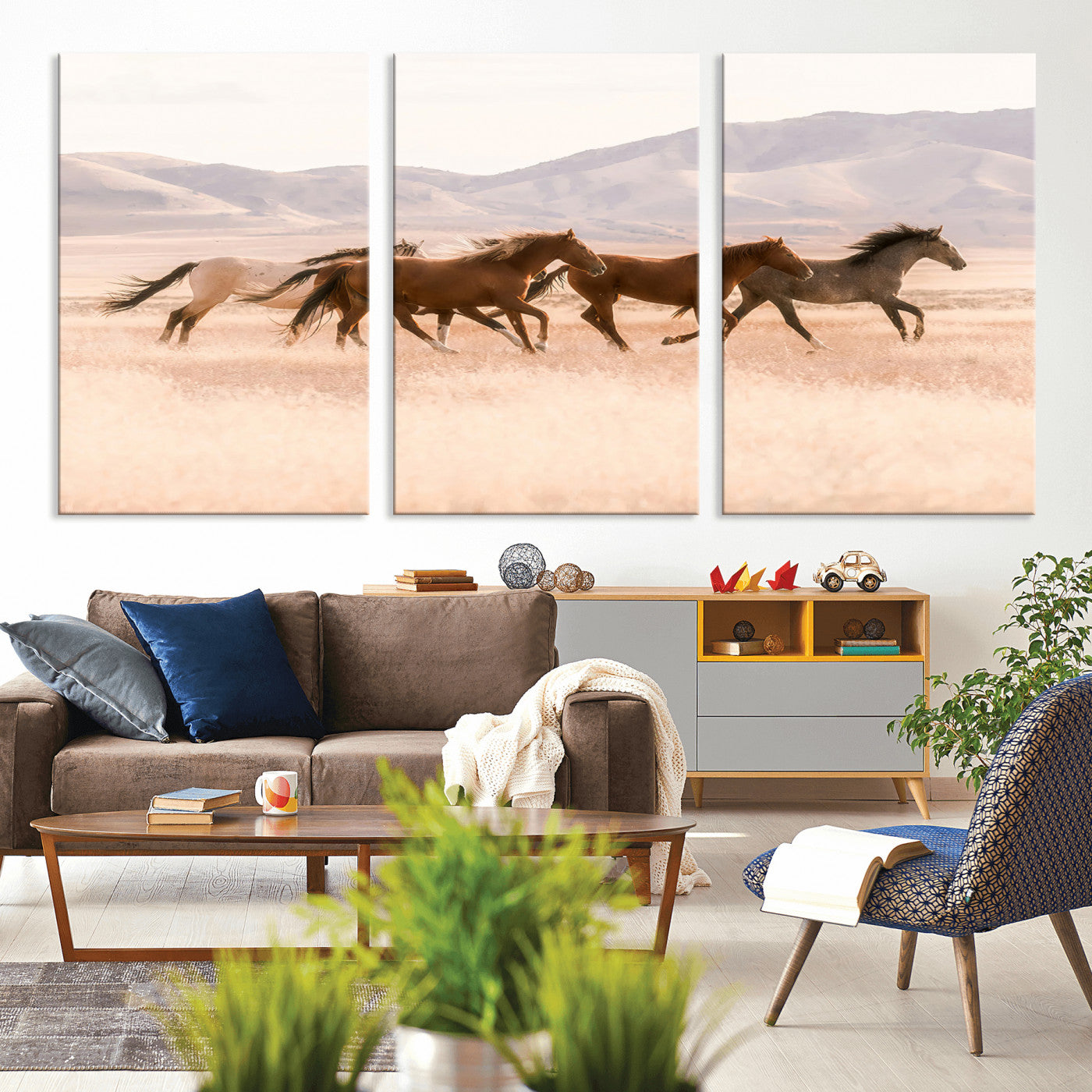 A herd of wild horses galloping through a sunlit desert plain with mountains in the background, perfect for rustic or western-themed wall decor.