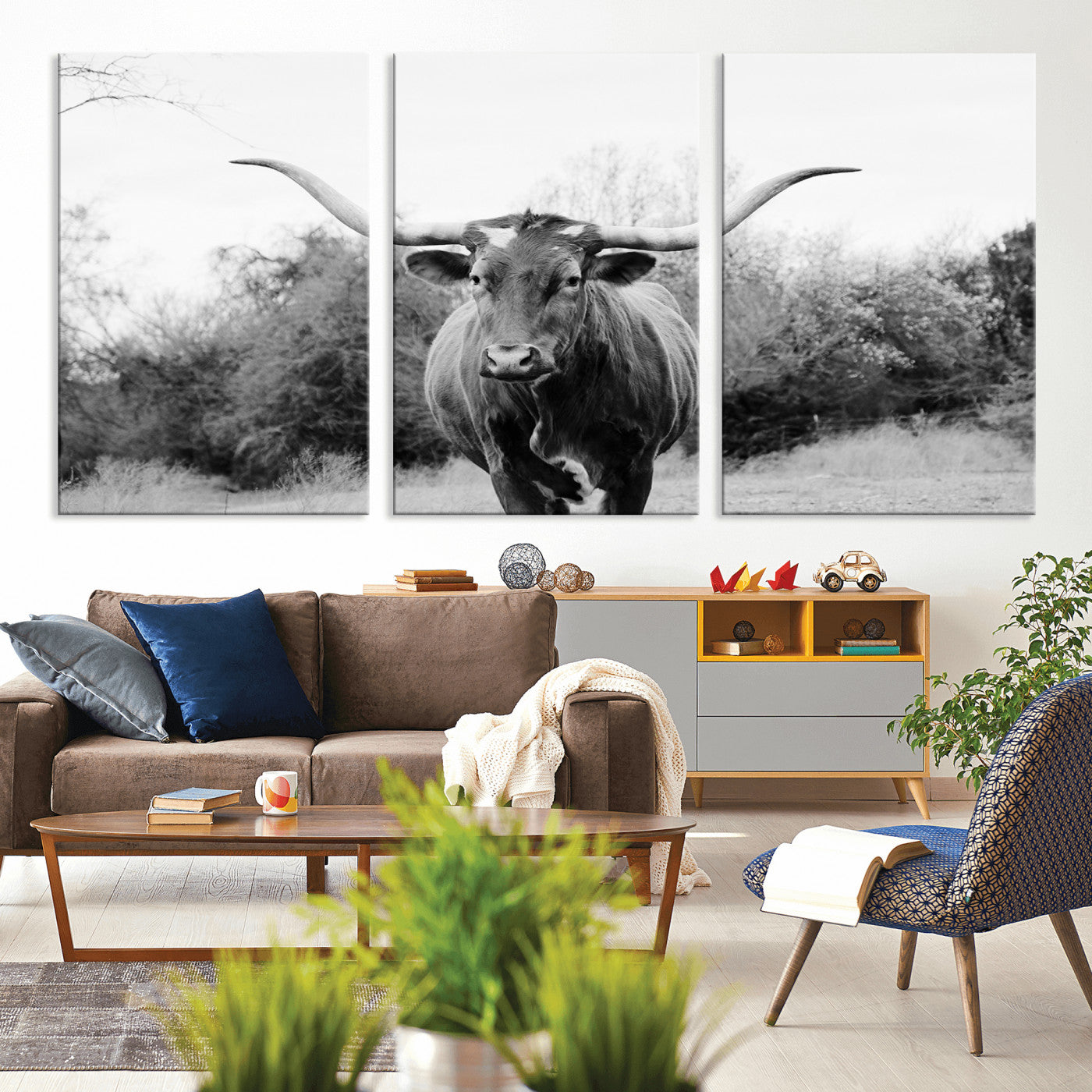 Black and white photo of a longhorn cow in a field, perfect for rustic farmhouse or western-themed interior wall decoration.