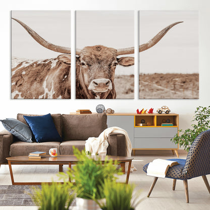 A longhorn cow in soft beige desert tones, standing calmly in open land, perfect for neutral western or rustic farmhouse interiors.