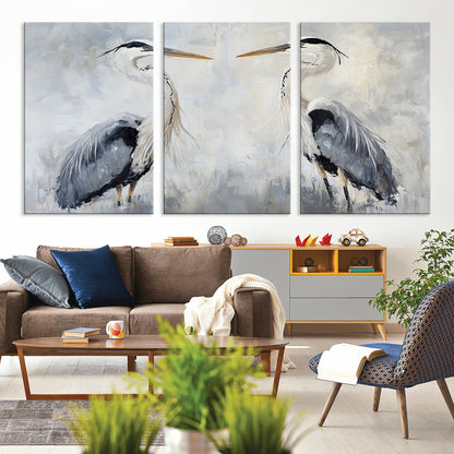 Two herons facing each other on a soft-toned background with blue-grey feathers, perfect for tranquil, coastal or nature-themed interiors.