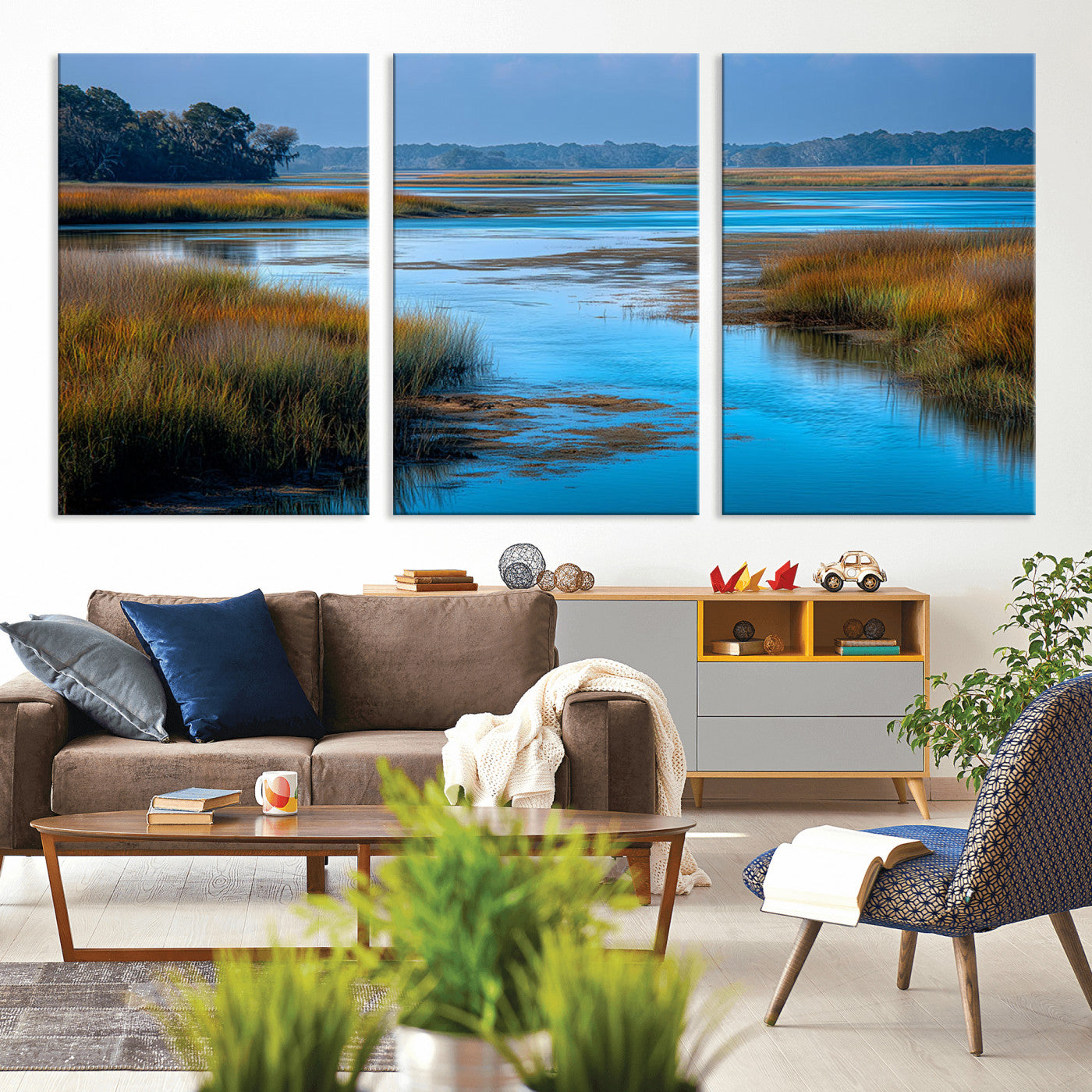 A peaceful marshland scene with calm blue water reflecting the surrounding grasses and trees, capturing the beauty of nature in a serene landscape.